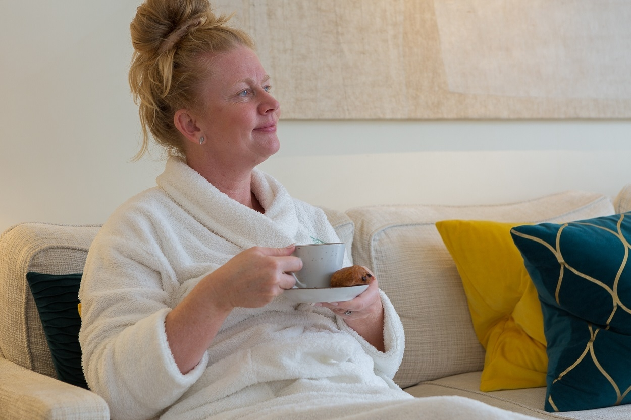 Weavers House Spa sofa with a coffee and a pastry