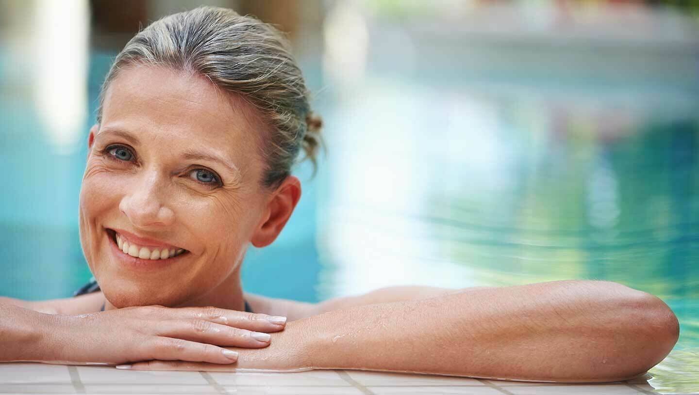 Lady resting on edge of pool