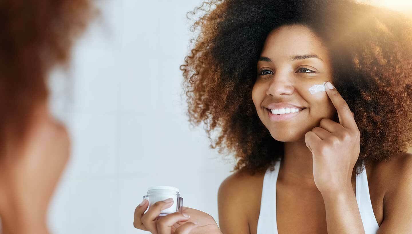Woman using moisturiser
